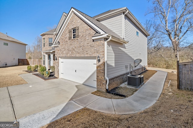 view of home's exterior featuring cooling unit and a garage