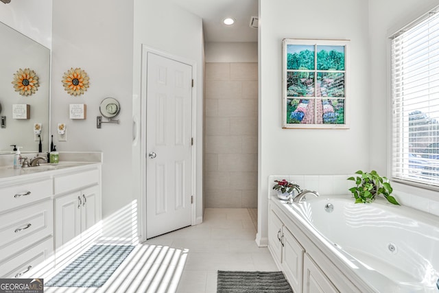 bathroom with tile patterned flooring, vanity, and a bathing tub