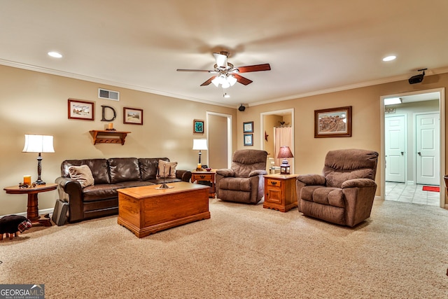 carpeted living room with ceiling fan and crown molding