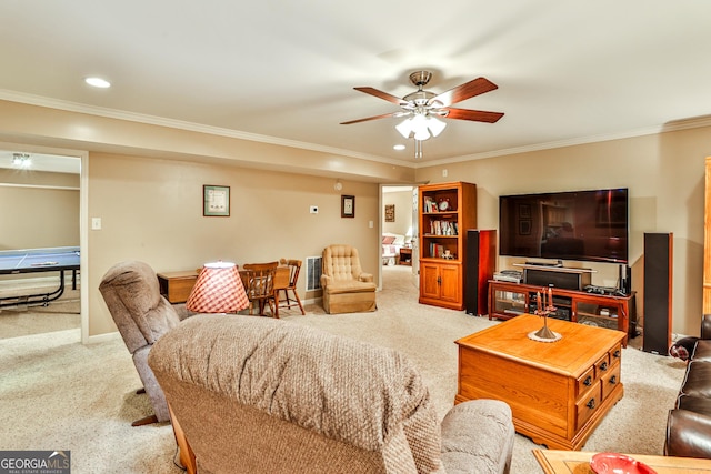 carpeted living room with crown molding and ceiling fan