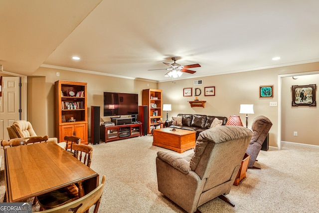 living room with ceiling fan, light colored carpet, and ornamental molding