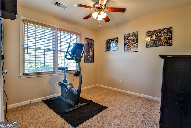 workout room featuring ceiling fan and carpet