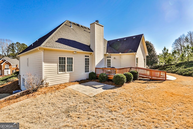 rear view of property featuring a wooden deck