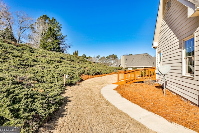 view of yard with a wooden deck