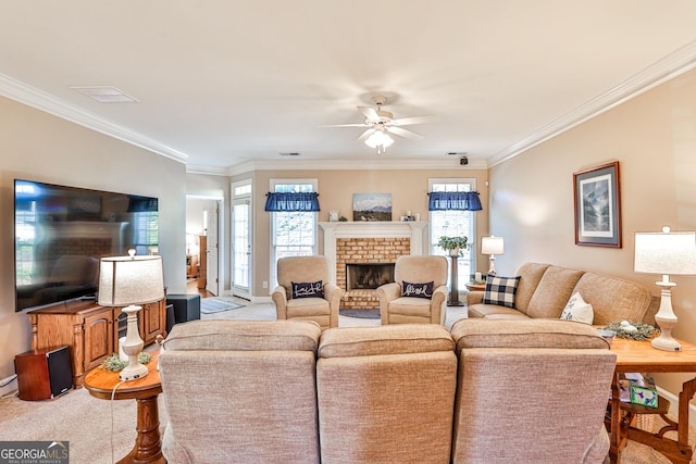 carpeted living room featuring a brick fireplace, ceiling fan, and ornamental molding