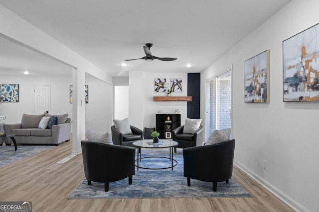 living room featuring hardwood / wood-style flooring and ceiling fan