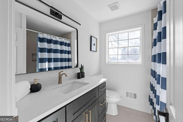 bathroom with tile patterned floors, vanity, and toilet