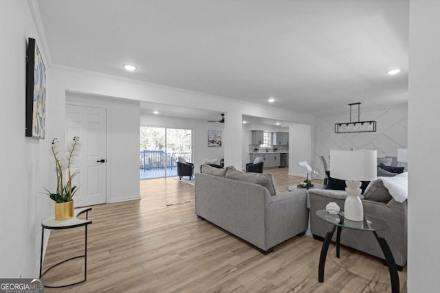 living room with light hardwood / wood-style floors and ornamental molding