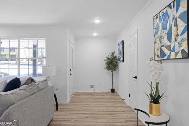 interior space with light hardwood / wood-style flooring and ornamental molding