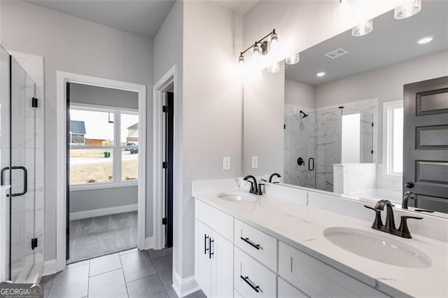 bathroom featuring tile patterned floors, vanity, and walk in shower