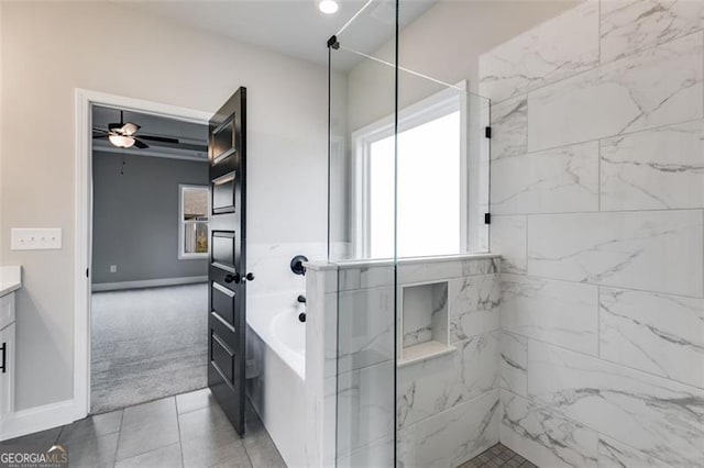 bathroom featuring tile patterned flooring, shower with separate bathtub, vanity, and ceiling fan