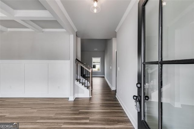 foyer entrance with crown molding, coffered ceiling, hardwood / wood-style floors, and beamed ceiling