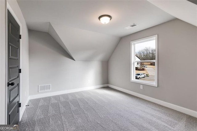 bonus room featuring carpet flooring and vaulted ceiling