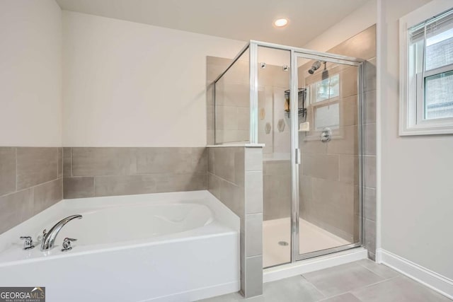 bathroom featuring tile patterned flooring and separate shower and tub