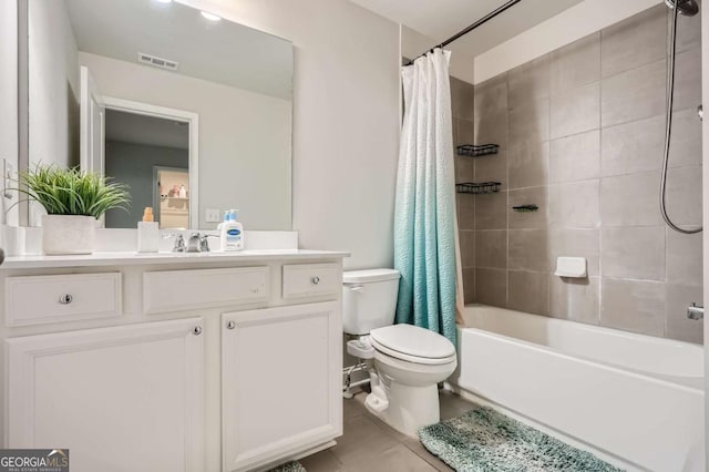 full bathroom with tile patterned flooring, vanity, toilet, and shower / bath combo with shower curtain