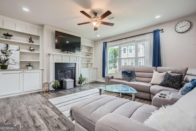 living room with light wood-type flooring and ceiling fan