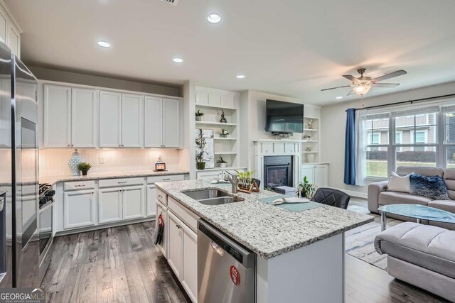 kitchen featuring white cabinetry, sink, an island with sink, and appliances with stainless steel finishes