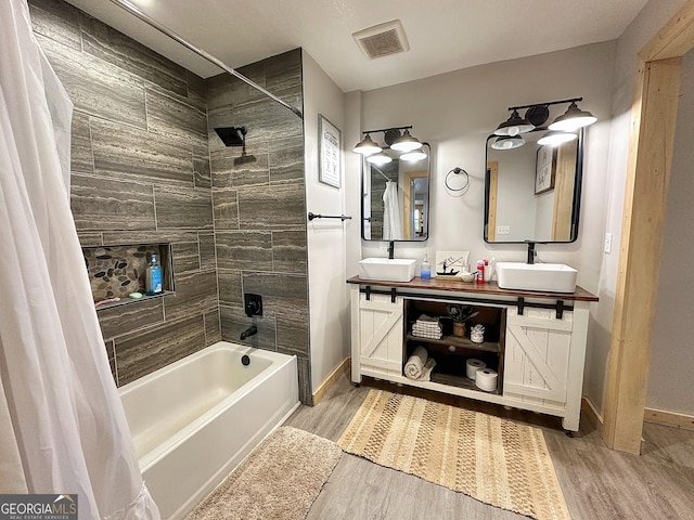 bathroom featuring shower / bath combo with shower curtain, vanity, and hardwood / wood-style flooring