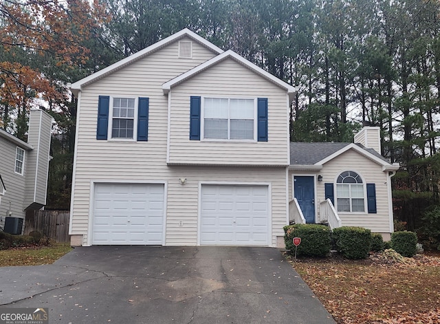 view of front of home featuring a garage and central air condition unit