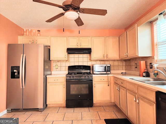 kitchen featuring light tile patterned floors, under cabinet range hood, light countertops, black appliances, and a sink