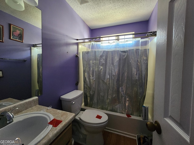 full bath with shower / bath combination with curtain, toilet, a textured ceiling, vanity, and wood finished floors