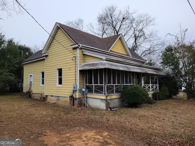 view of home's exterior with a sunroom