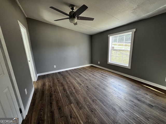 spare room featuring a textured ceiling, dark hardwood / wood-style floors, and ceiling fan