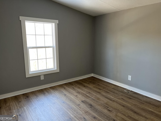 empty room featuring hardwood / wood-style flooring and a healthy amount of sunlight