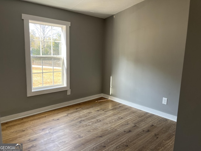 empty room with wood-type flooring