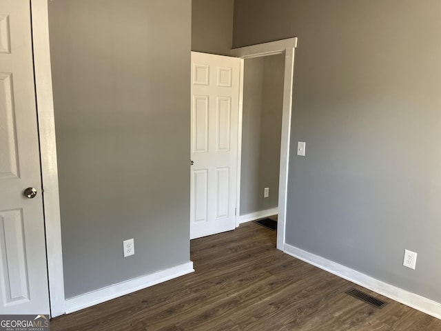 empty room with dark hardwood / wood-style floors