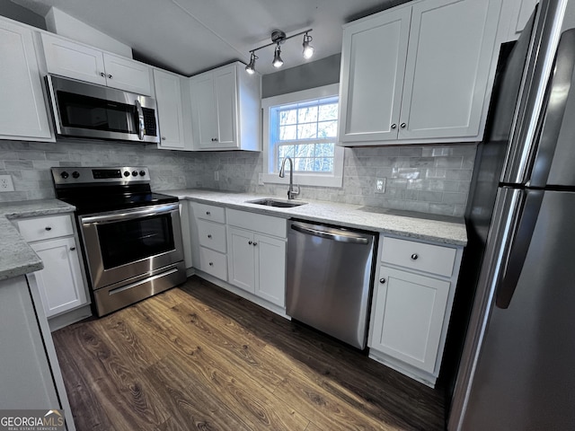 kitchen with white cabinets, sink, appliances with stainless steel finishes, and dark wood-type flooring