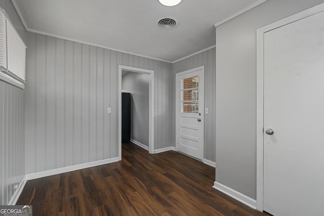 unfurnished room featuring ornamental molding and dark hardwood / wood-style floors