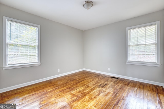 spare room with light hardwood / wood-style flooring