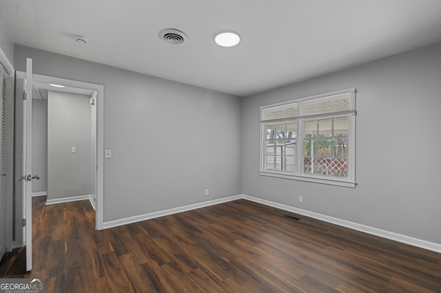 unfurnished room featuring dark hardwood / wood-style floors