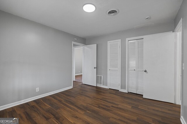 unfurnished bedroom featuring wooden walls, hardwood / wood-style flooring, and crown molding