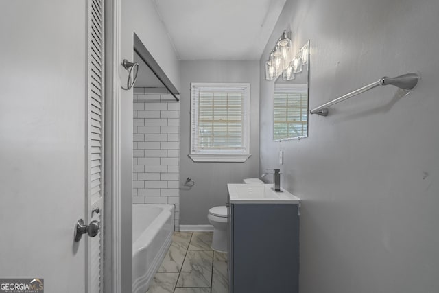 full bathroom with tiled shower / bath, vanity, and toilet