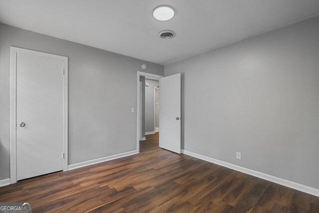 unfurnished bedroom with hardwood / wood-style flooring