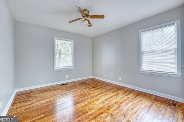 unfurnished room with ceiling fan and light hardwood / wood-style floors