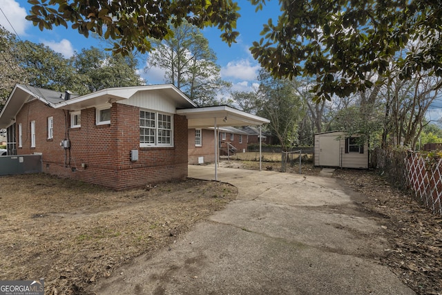 view of property exterior with a carport and a shed