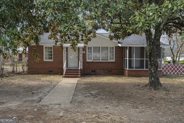 view of front of home featuring a sunroom