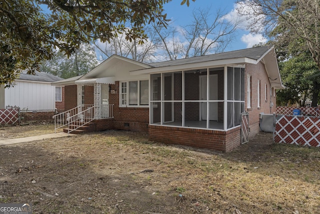 view of front of house featuring a sunroom