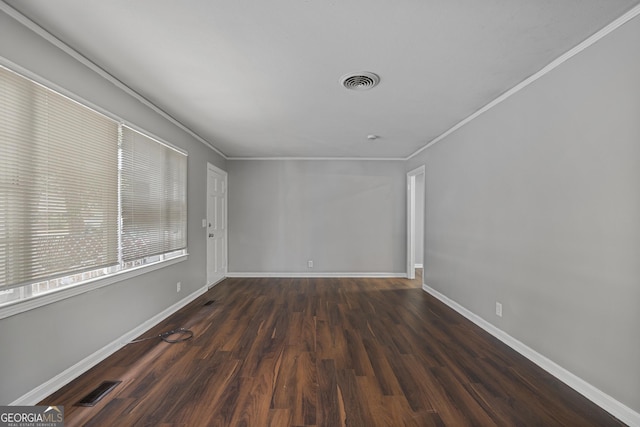 empty room with crown molding and dark hardwood / wood-style floors