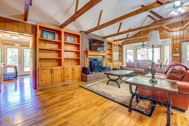 living room featuring beam ceiling, ceiling fan, high vaulted ceiling, and light hardwood / wood-style flooring