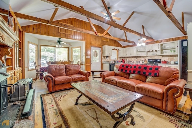 living room with beamed ceiling and high vaulted ceiling