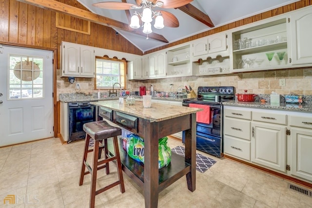 kitchen featuring white cabinetry, vaulted ceiling with beams, and black appliances