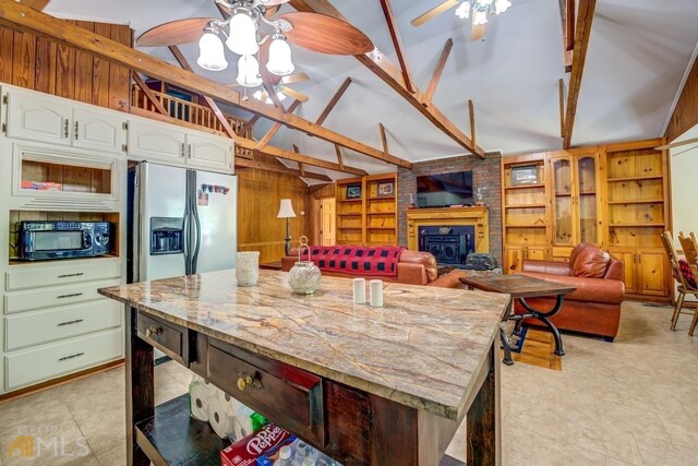 dining space featuring beamed ceiling and high vaulted ceiling