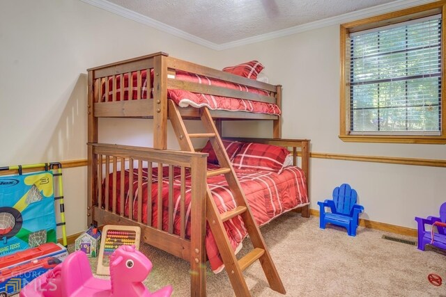 carpeted bedroom featuring crown molding and a textured ceiling