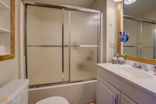 full bathroom featuring vanity, enclosed tub / shower combo, and toilet