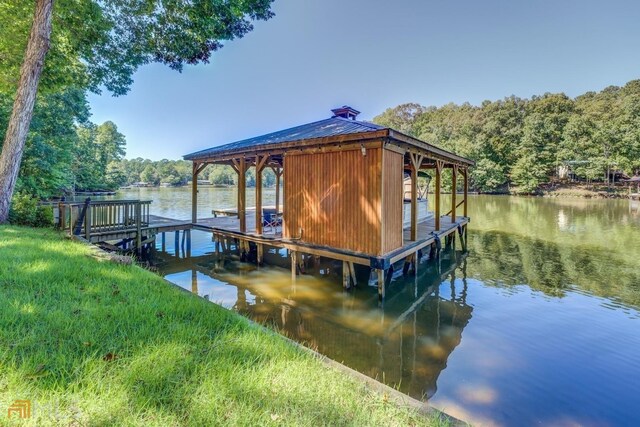 view of front of house with a water view and a front lawn