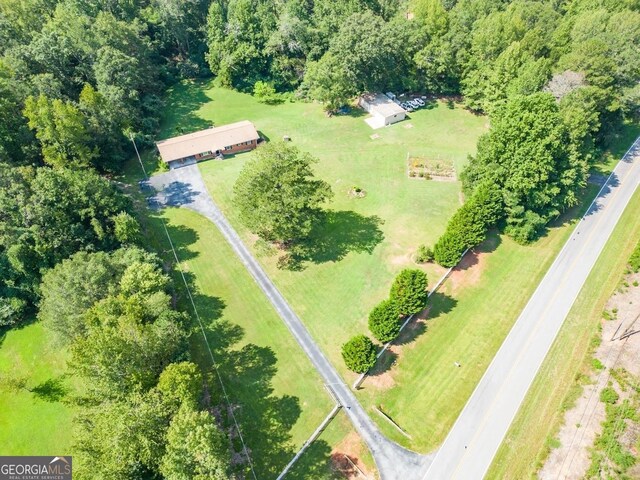 ranch-style home with a carport and a front lawn